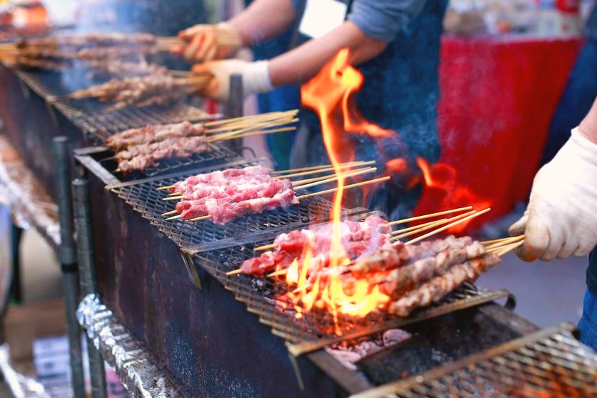 Skewers grilling at a food vendor