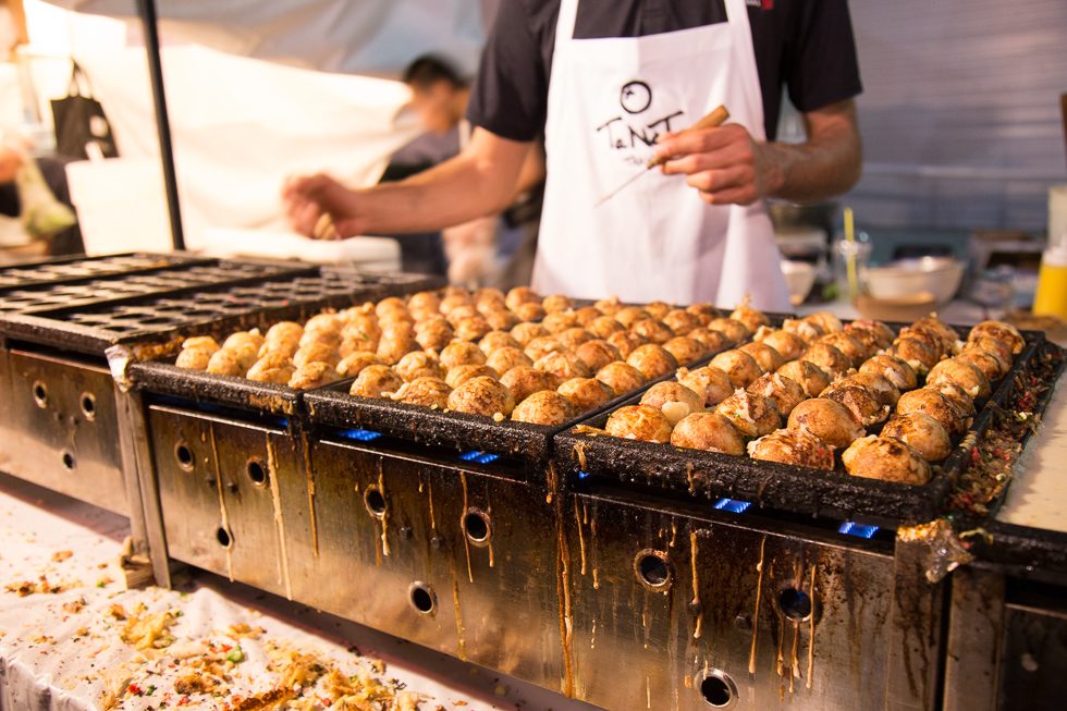 Fresh takoyaki grilling at a food stall